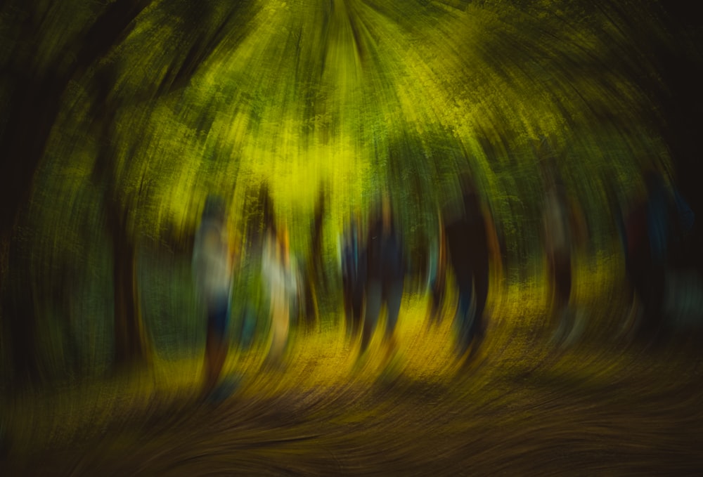 a blurry photo of a group of people walking through a forest