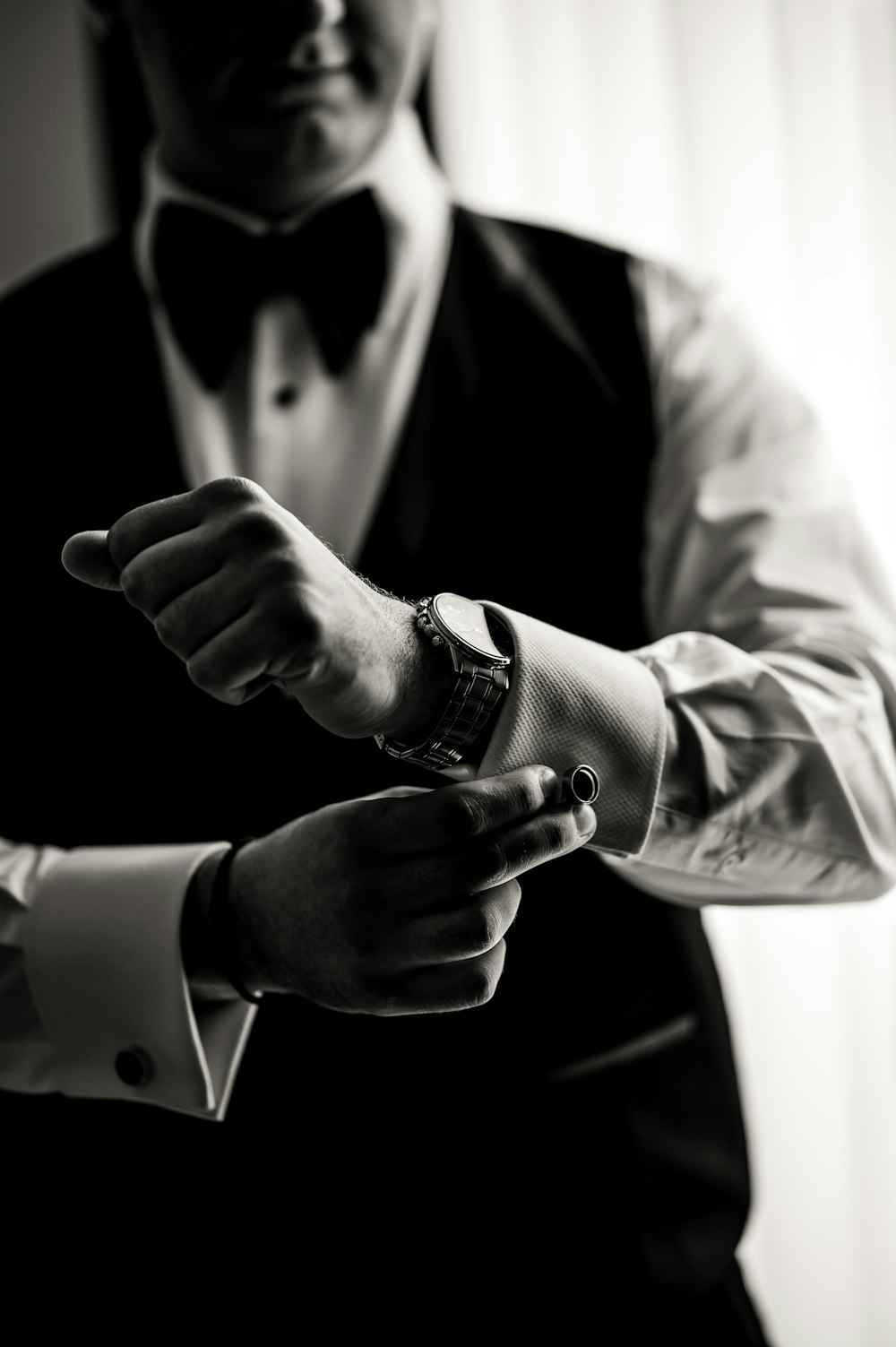 a black and white photo of a man in a tuxedo