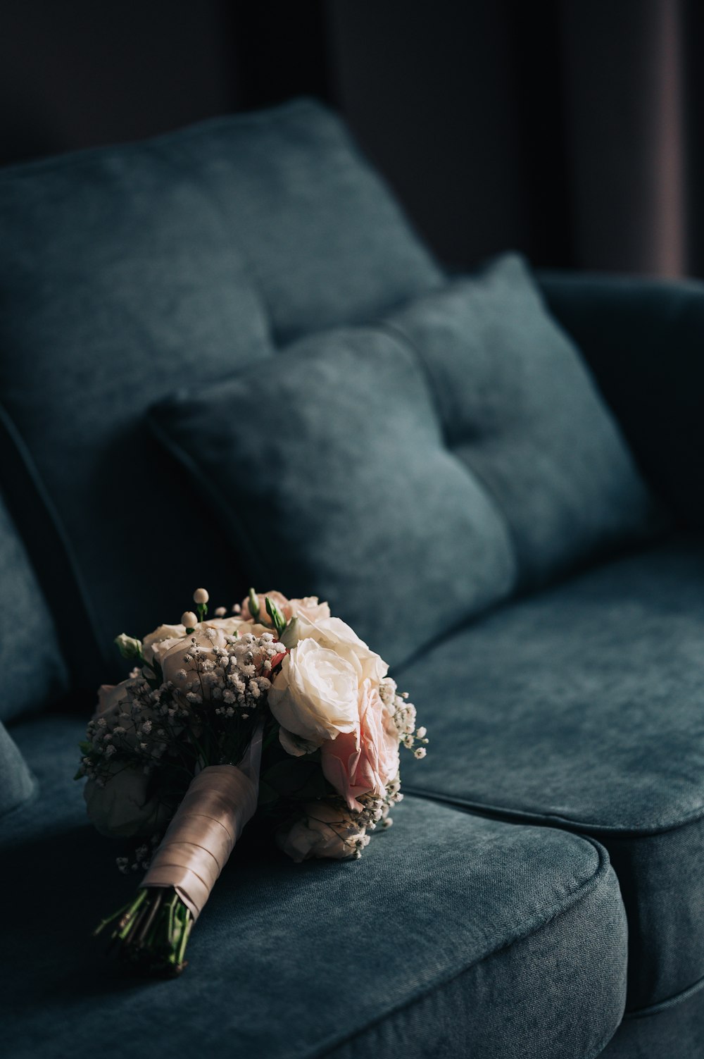 a bouquet of flowers sitting on a couch