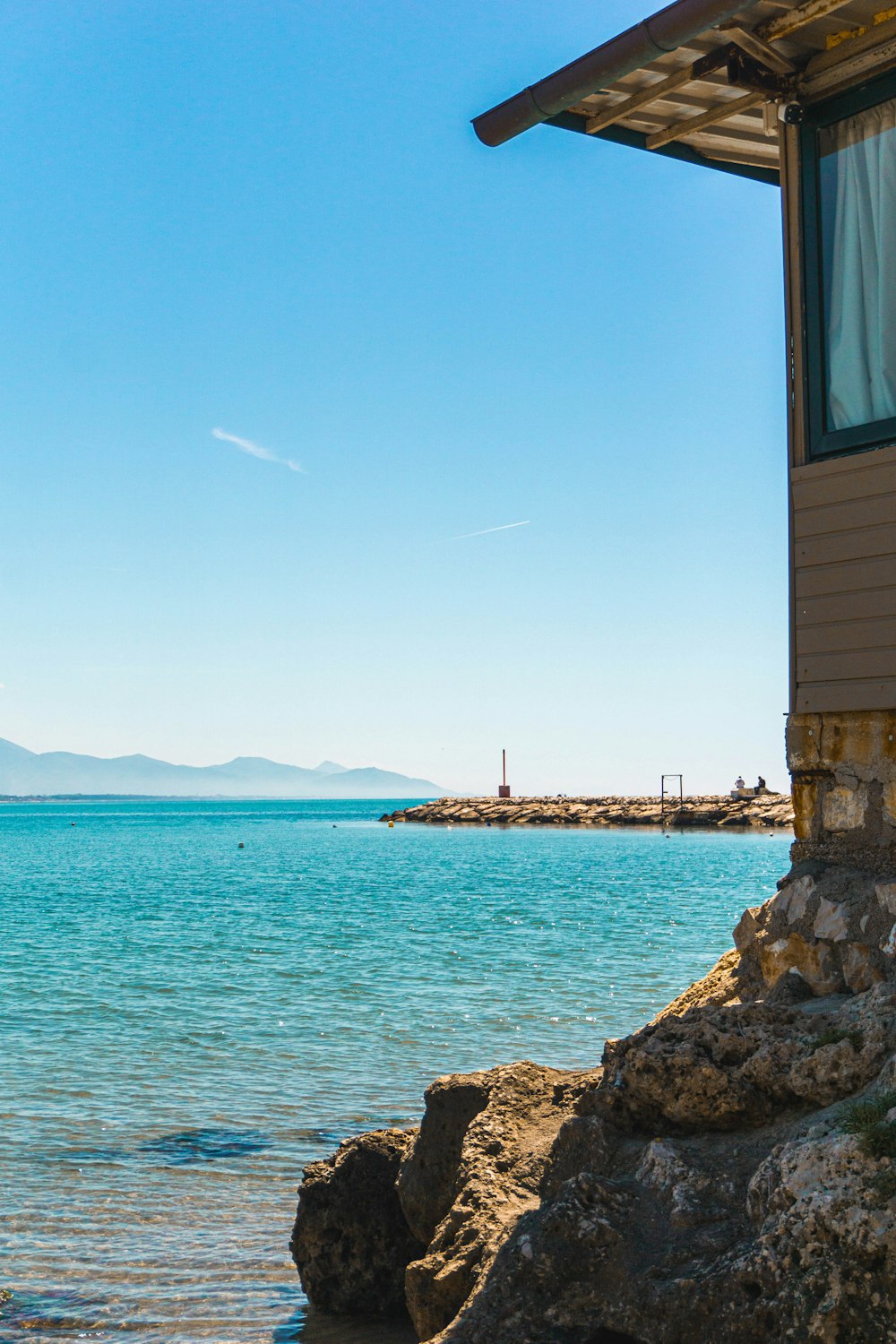 a house sitting on the shore of a body of water