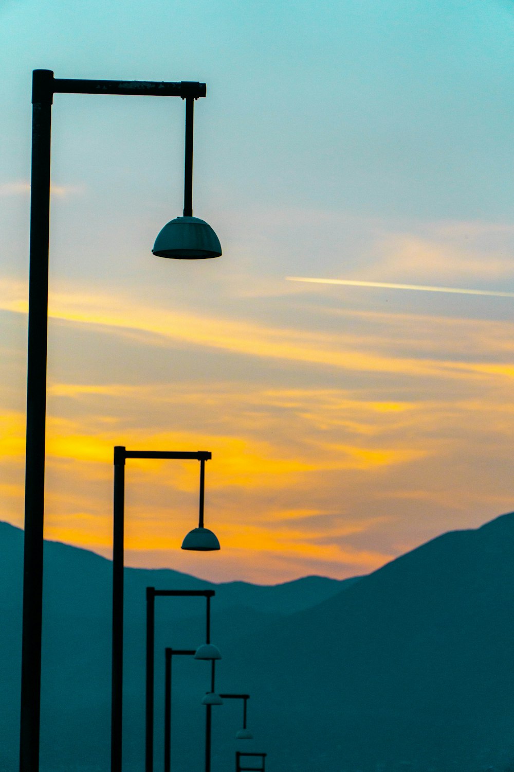 a street light with mountains in the background