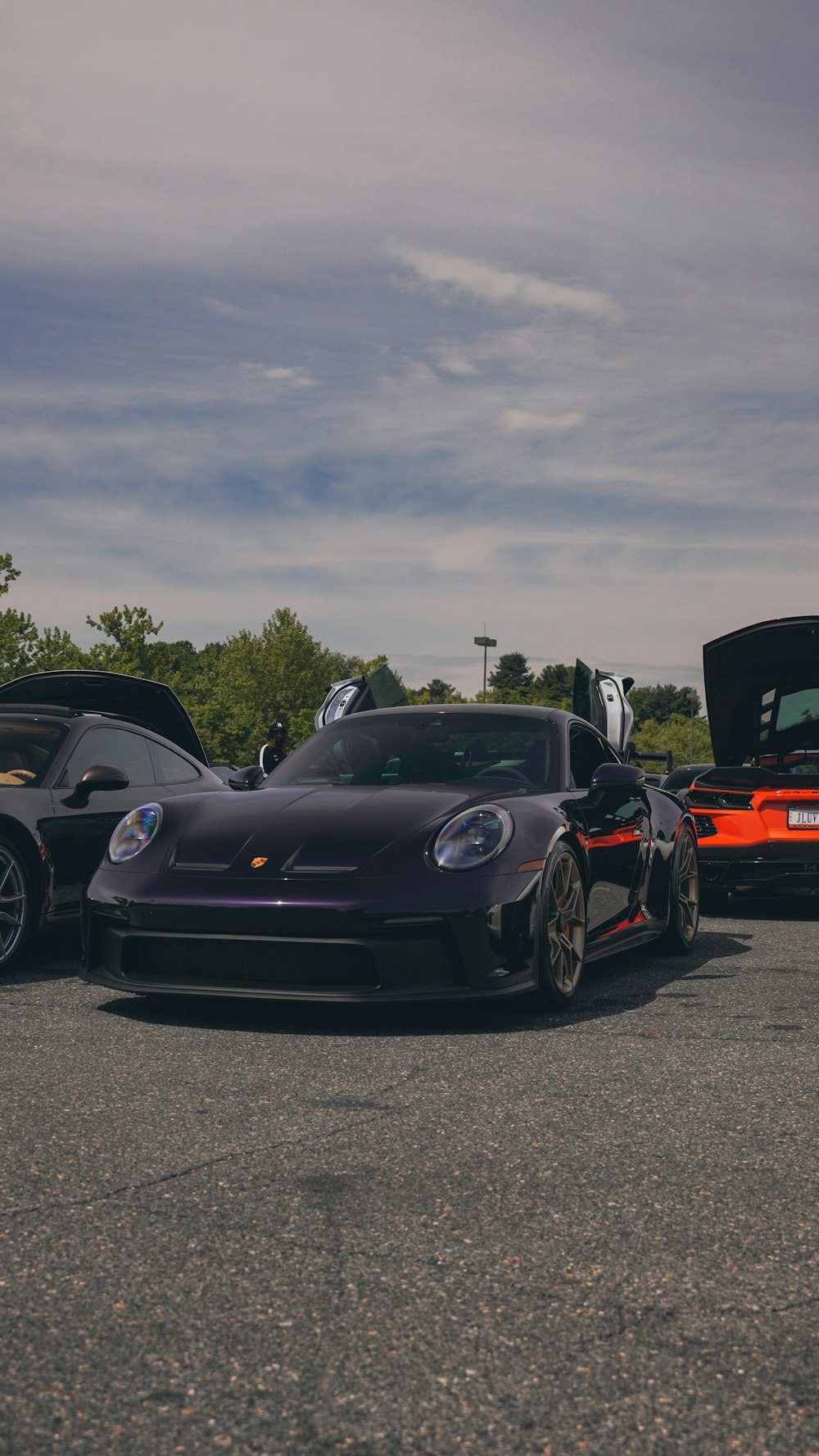 a group of cars parked next to each other in a parking lot