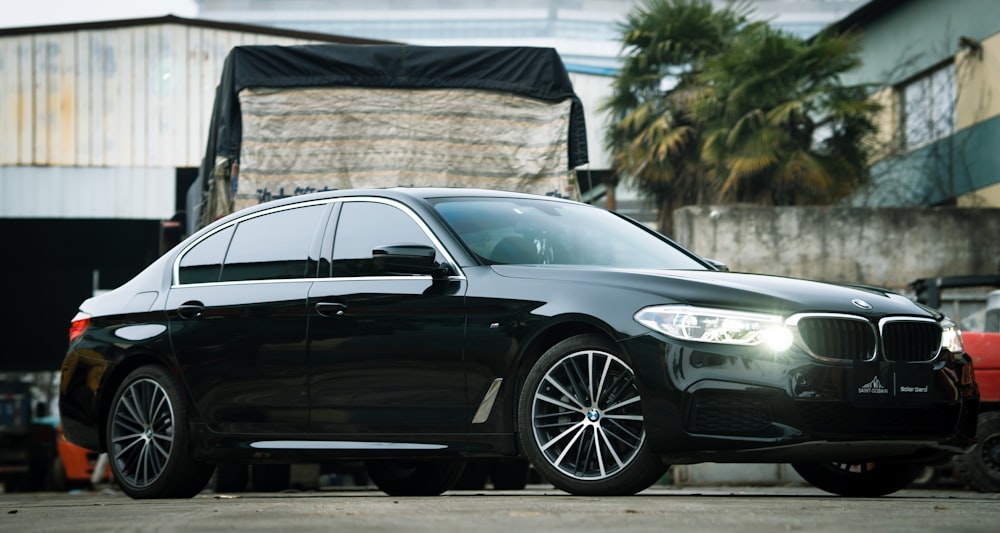 a black car parked in front of a building