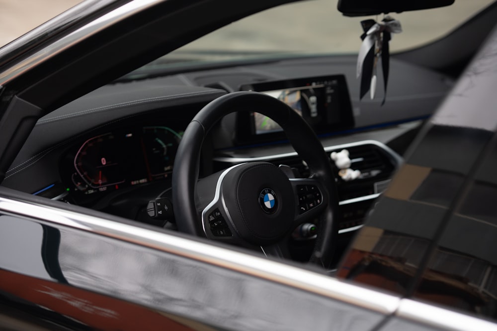 the interior of a car with a steering wheel and dashboard