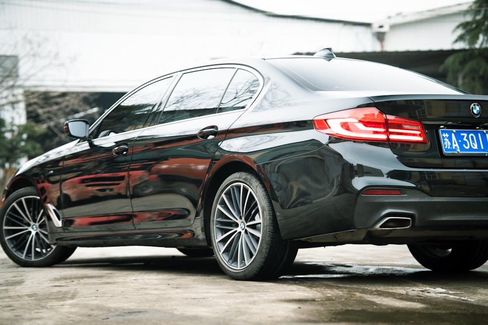 a black car parked in front of a building