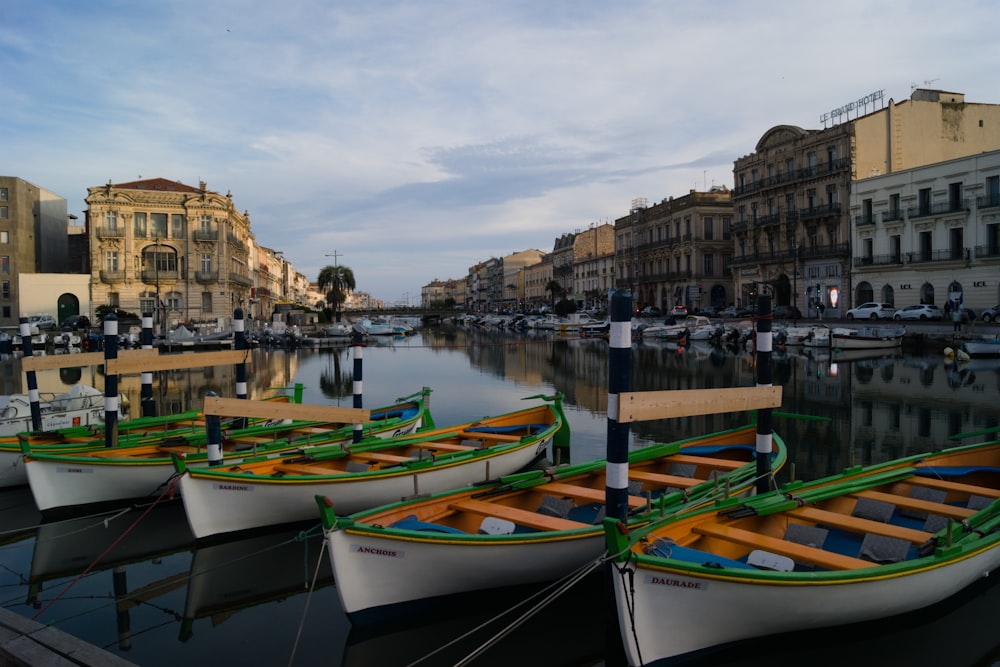 a row of boats sitting next to each other on a river