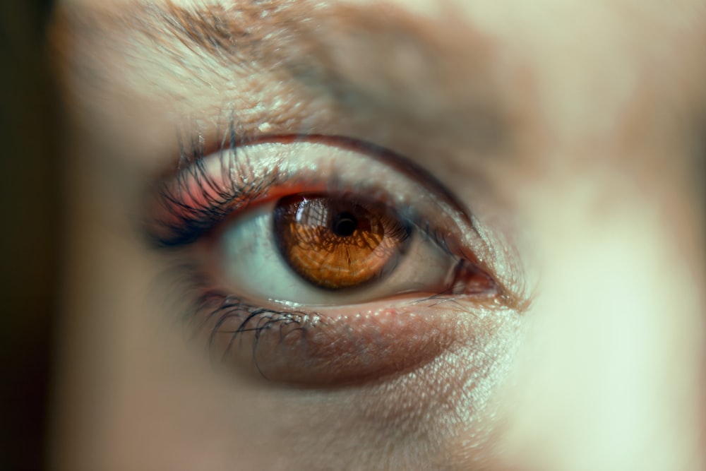 a close up of a person's brown eye