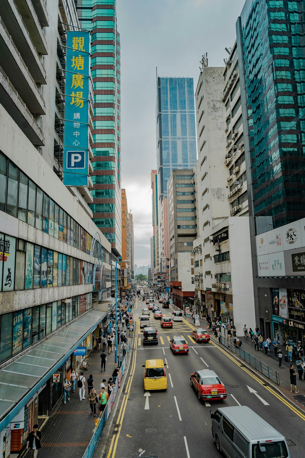 a city street filled with lots of traffic and tall buildings