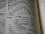 An open page of a book, likely a Bible, with text printed in columns. The section features prominent headings and verse numbers, with some words highlighted in bold.