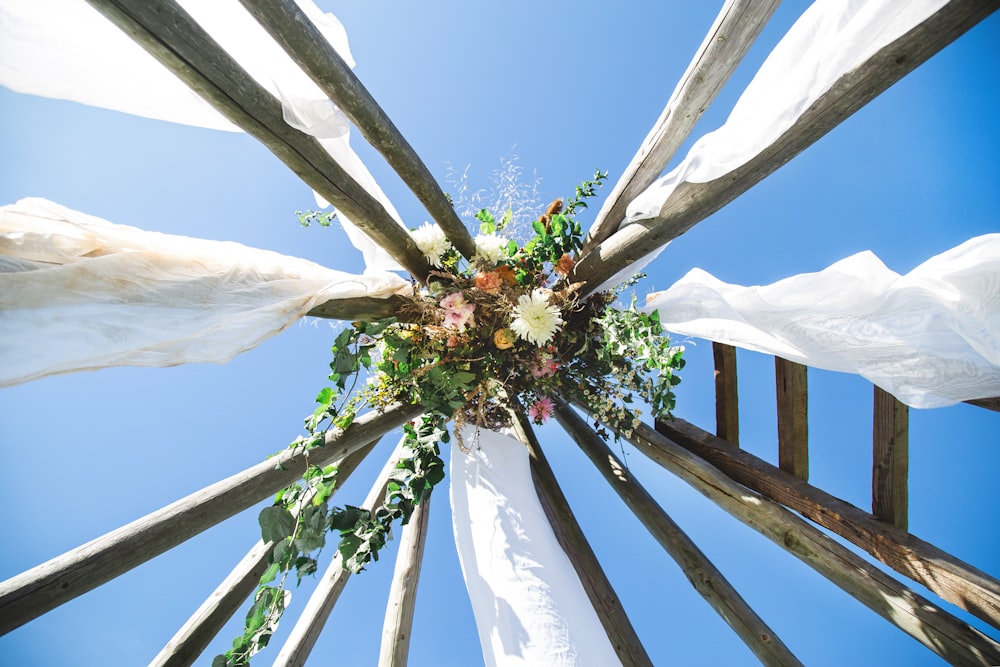 a wedding arch with flowers and greenery on it