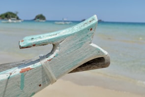 Close-up of a classic wooden sailboat's bow cutting through waves