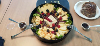 Close-up of a beautifully arranged platter showcasing artisanal cheeses, olives, and fresh berries.