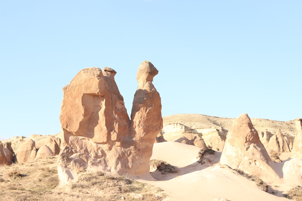 a couple of large rocks sitting in the middle of a desert