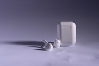 Wireless earphones and power banks displayed with modern lighting highlighting their features.