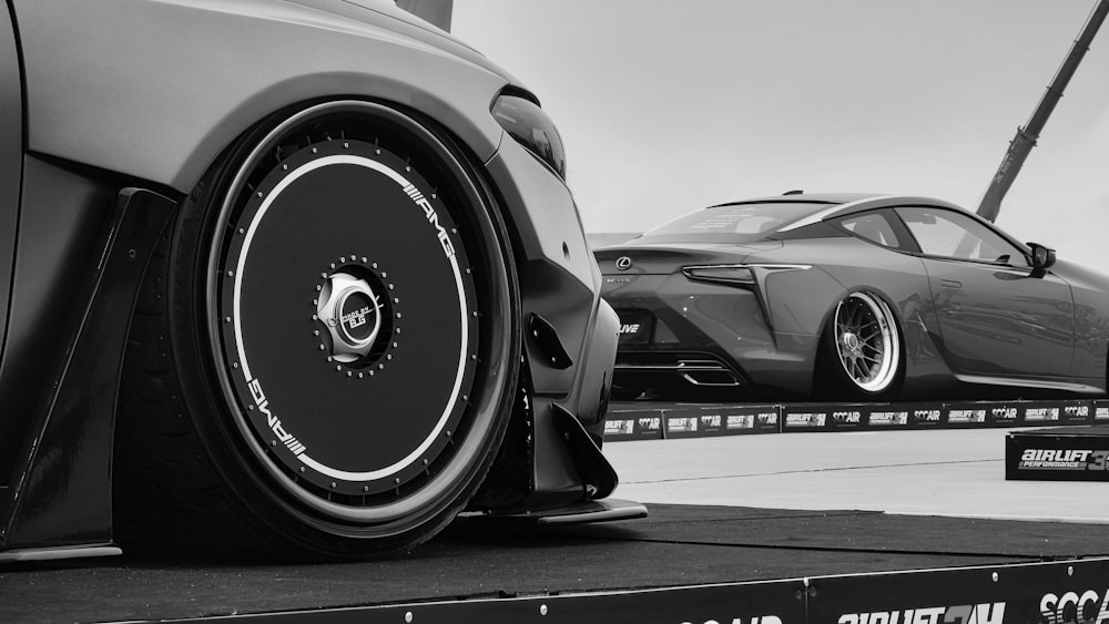 a black and white photo of a car being towed by a tow truck