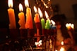 Close-up of elegant menorahs glowing softly in a cozy room.