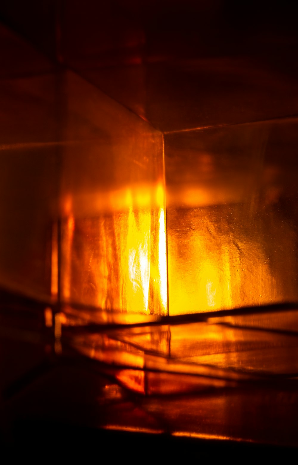 a close up of a lit candle in a dark room