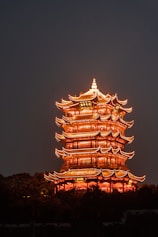 a tall tower lit up in the night sky