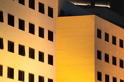 Smart building facade illuminated with IoT connected devices at dusk.