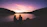 A happy couple enjoying a meal with the shimmering Lake Pichola in the background at sunset.