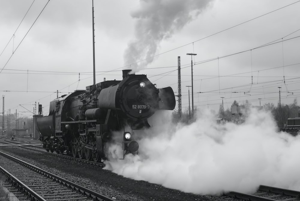 a black and white photo of a steam engine train