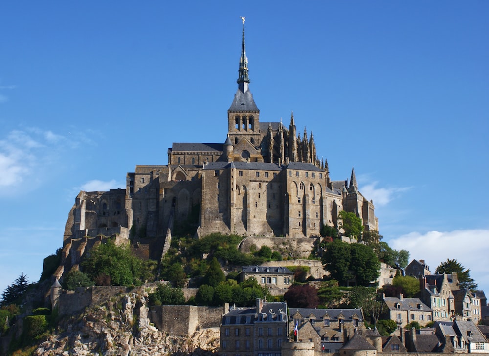 a castle on top of a hill with a sky background