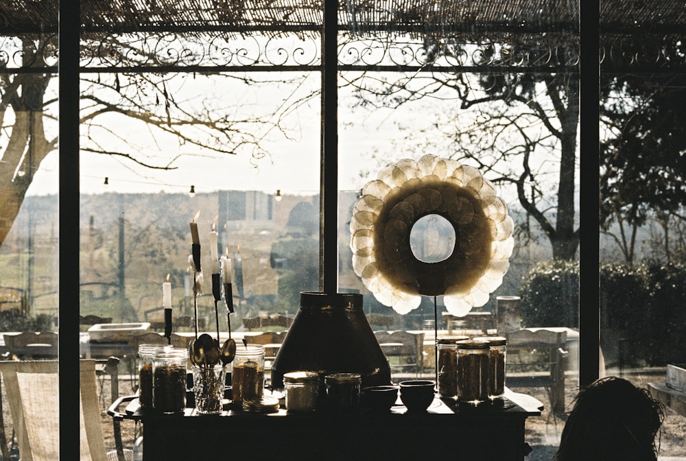 a table with a lamp and other items on it