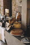 A cozy kitchen scene with fresh baked bread and homemade preserves.