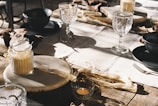 A rustic table set with syrup bottles and natural elements.