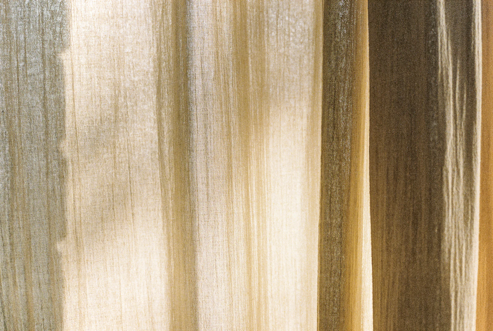 Sunlight glowing through hanging natural linen