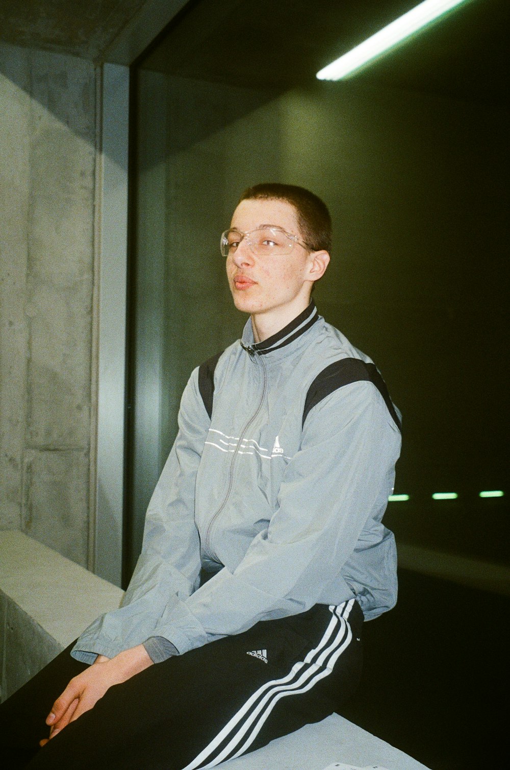 a man sitting on a ledge in a building