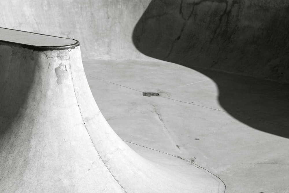 a black and white photo of a skateboard ramp
