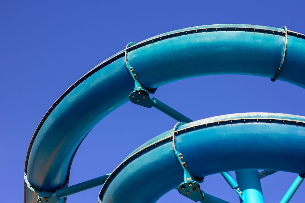 a blue water slide against a blue sky