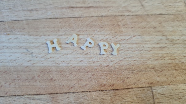 Handcrafted isopor letters spelling out a festive message on a wooden table