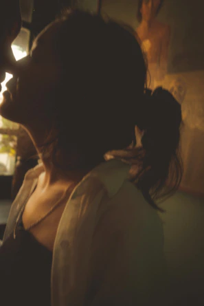 Portrait shot from 'Tante Iki' capturing an intimate moment with warm tones.
