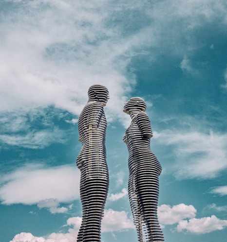 a couple of tall statues standing next to each other