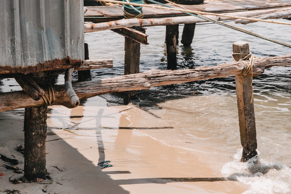 a close up of a wooden dock with a boat in the background