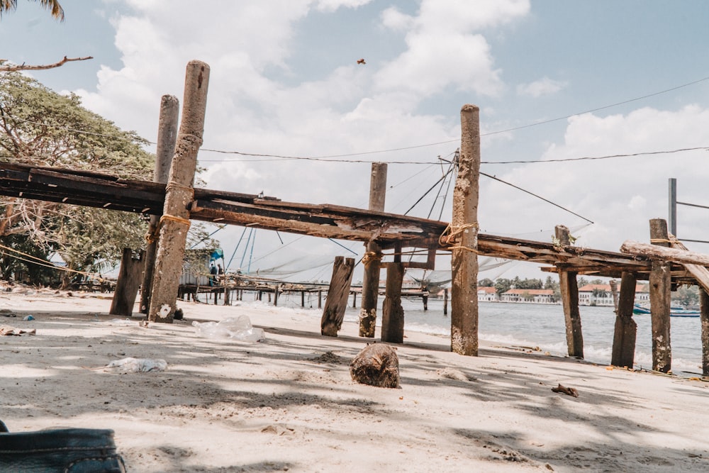 a wooden structure sitting on top of a sandy beach