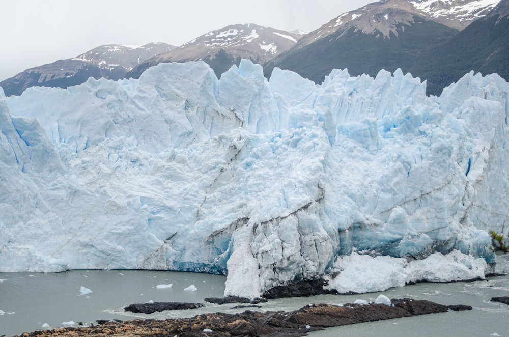 a large iceberg with a bunch of snow on top of it