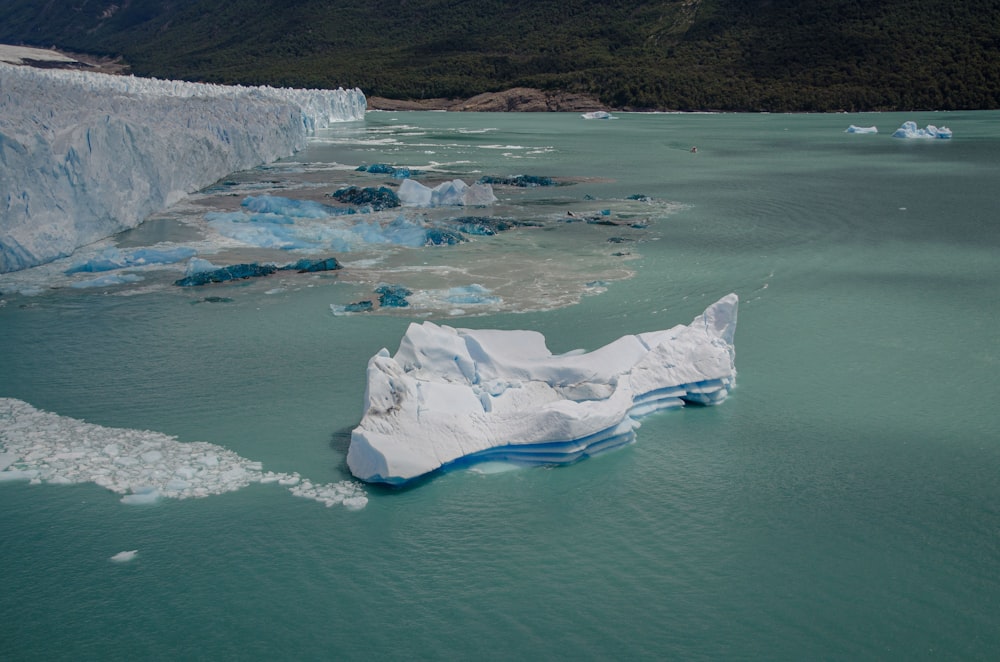 a large iceberg floating in the middle of a body of water