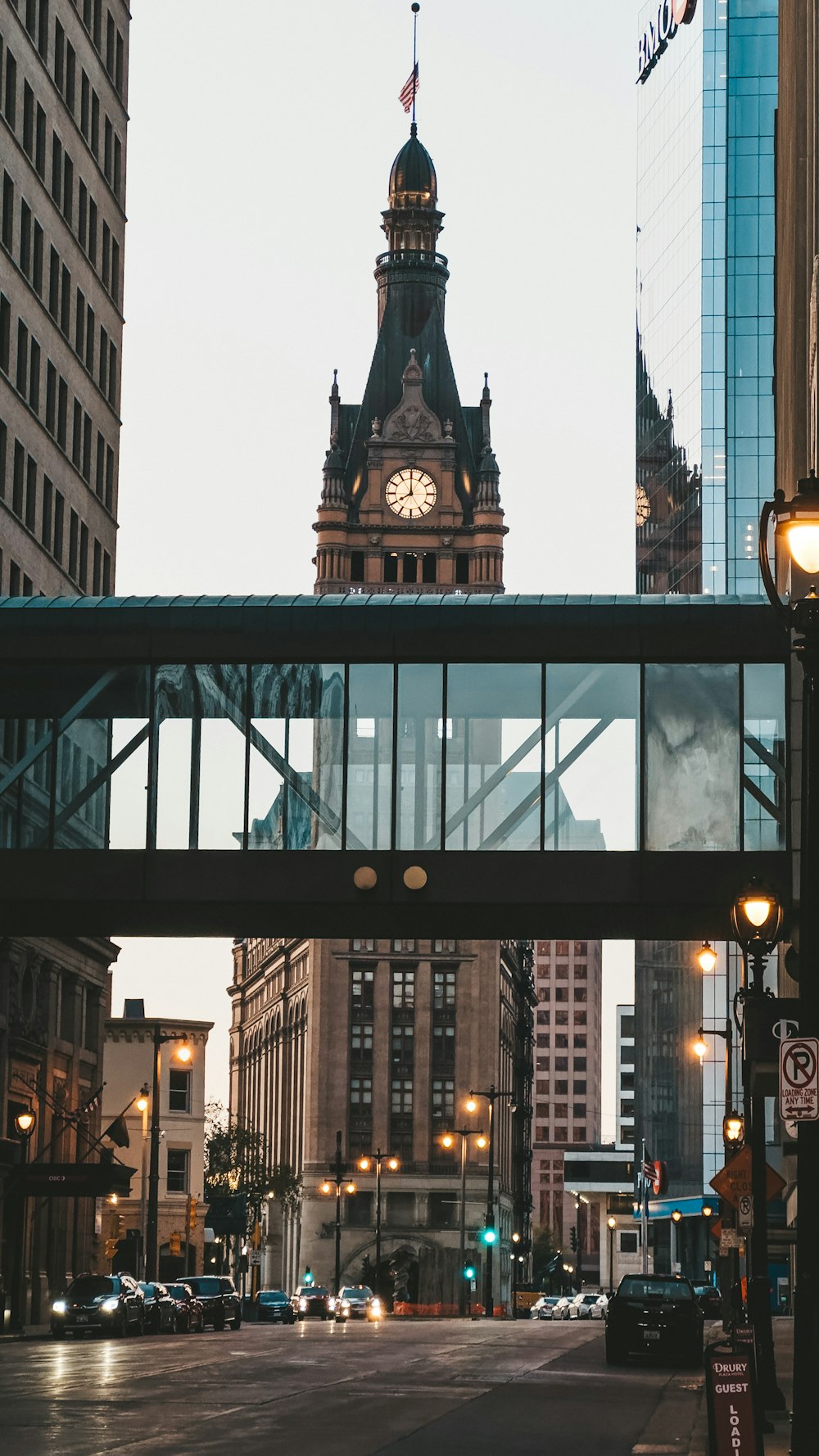 a clock tower towering over a city street