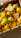 A satisfied customer holding fresh lemons in a bright warehouse.