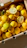 A satisfied customer holding fresh lemons in a bright warehouse.