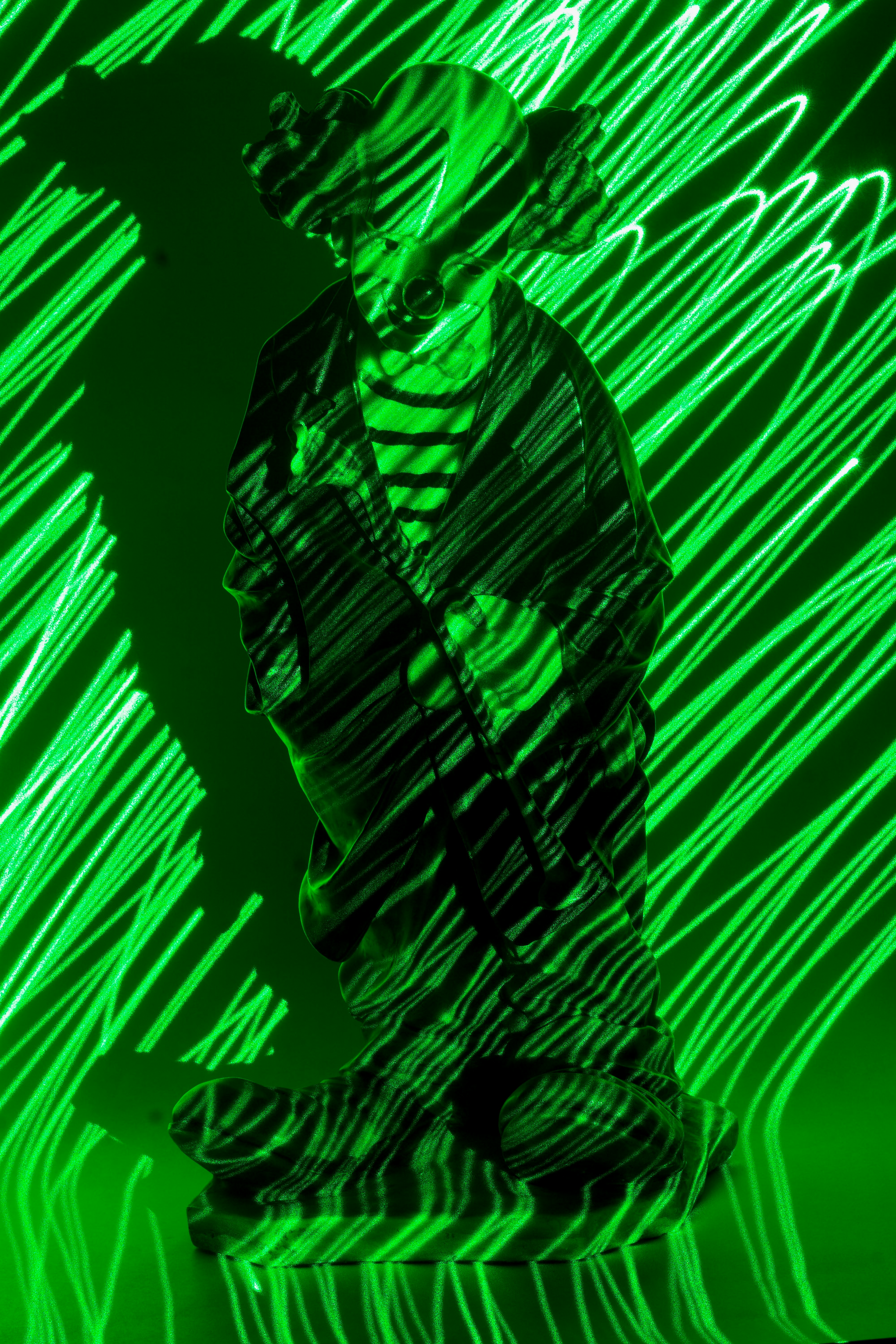a man sitting in front of a green light