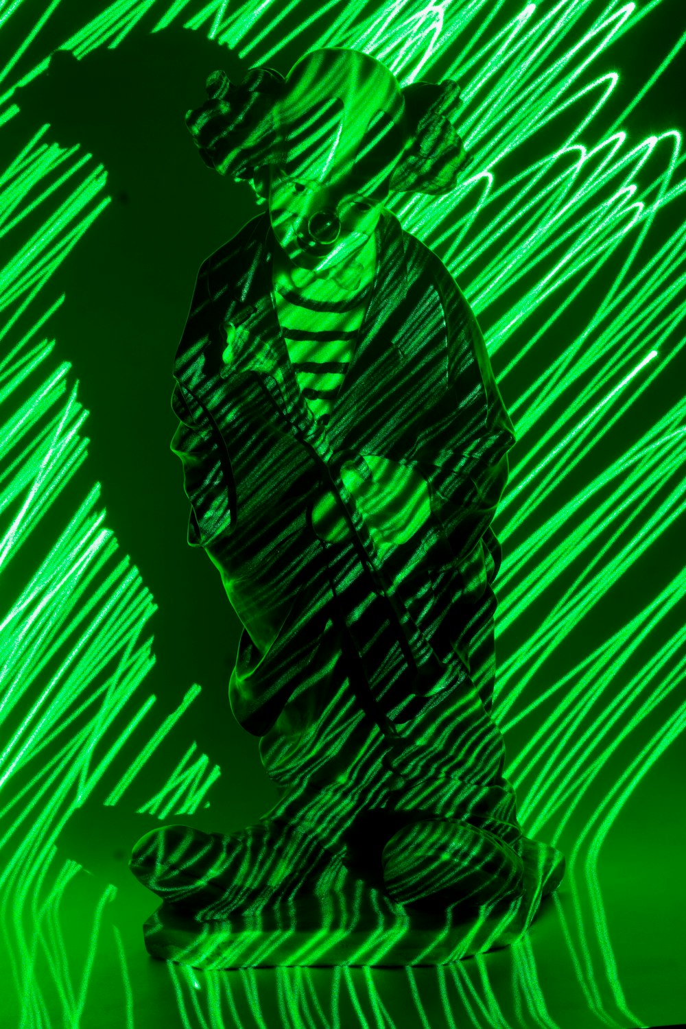 a man sitting in front of a green light