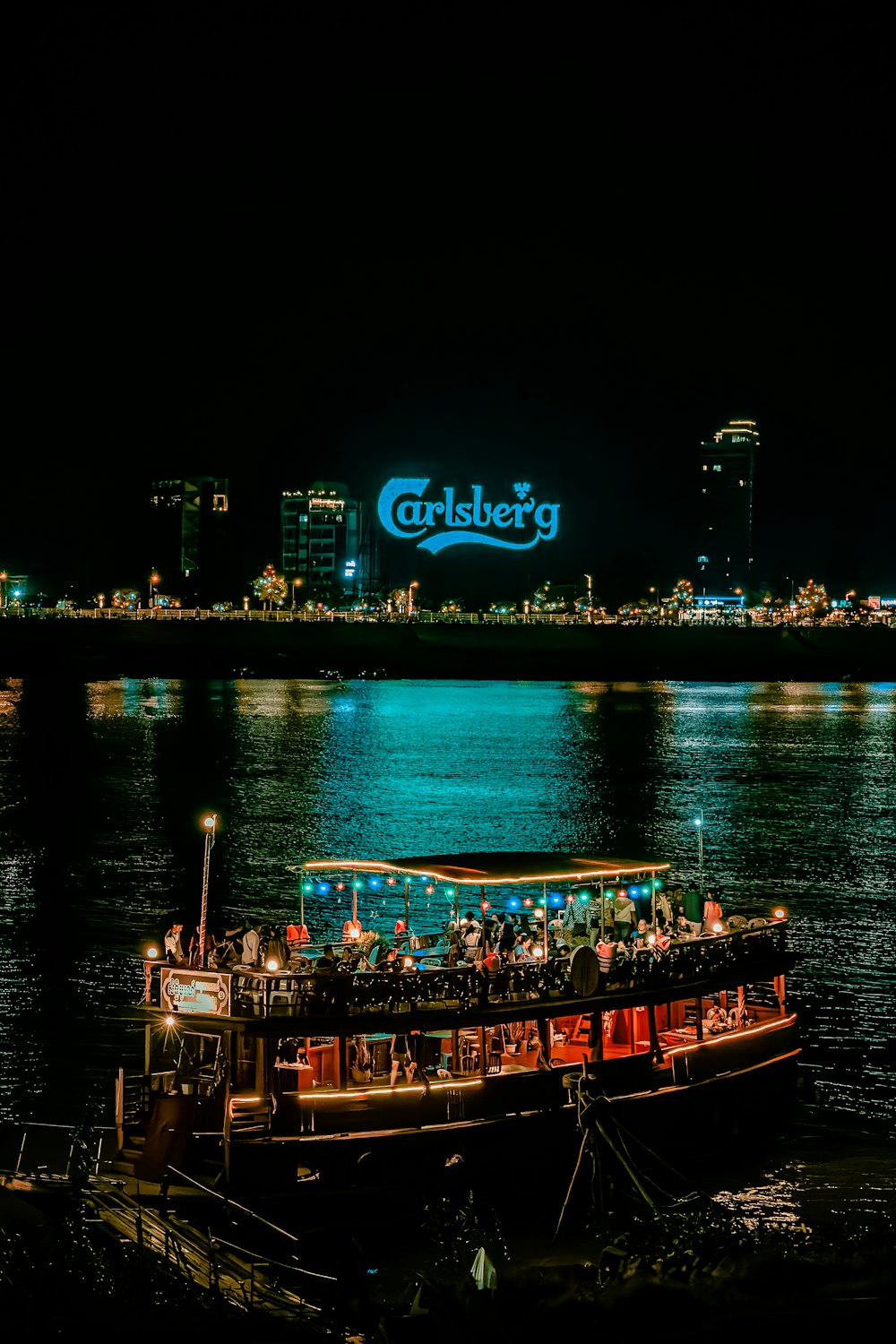 a boat with people on it floating in the water