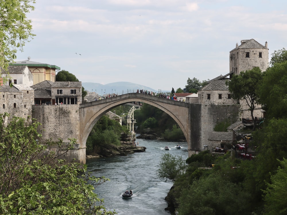 a bridge over a river with a boat on it