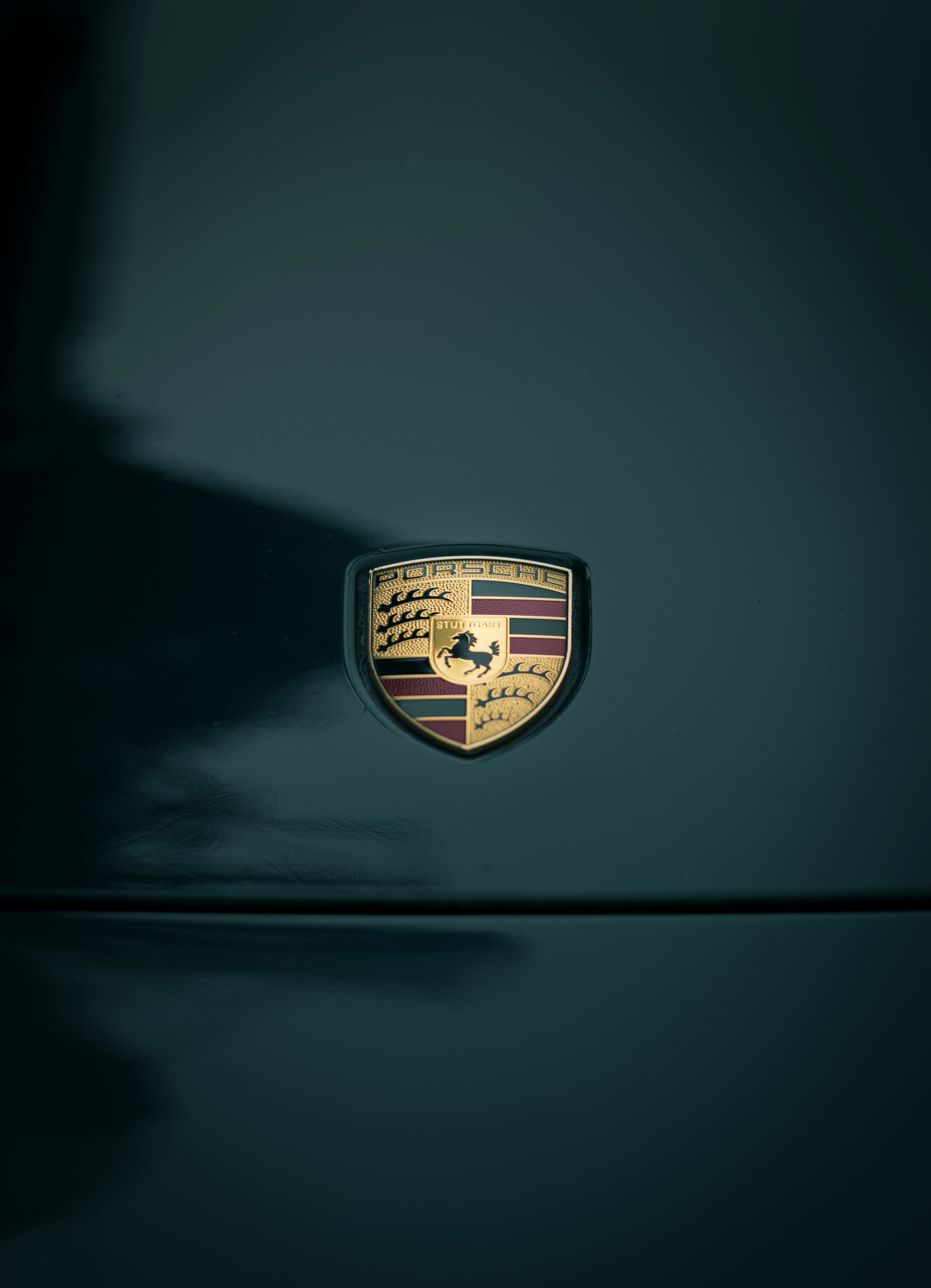 a close up of the emblem on a green car