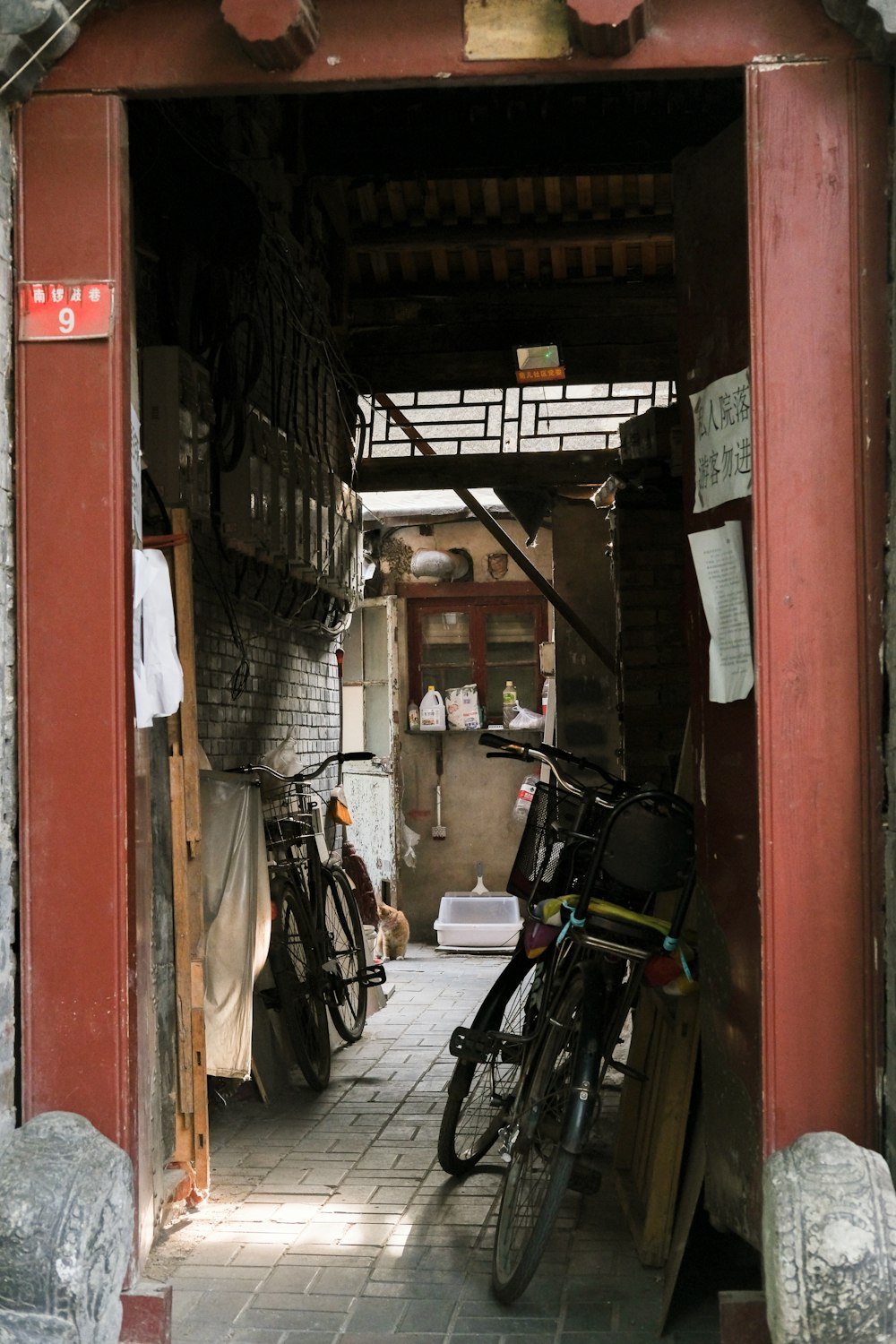 a narrow alley with bikes parked in it