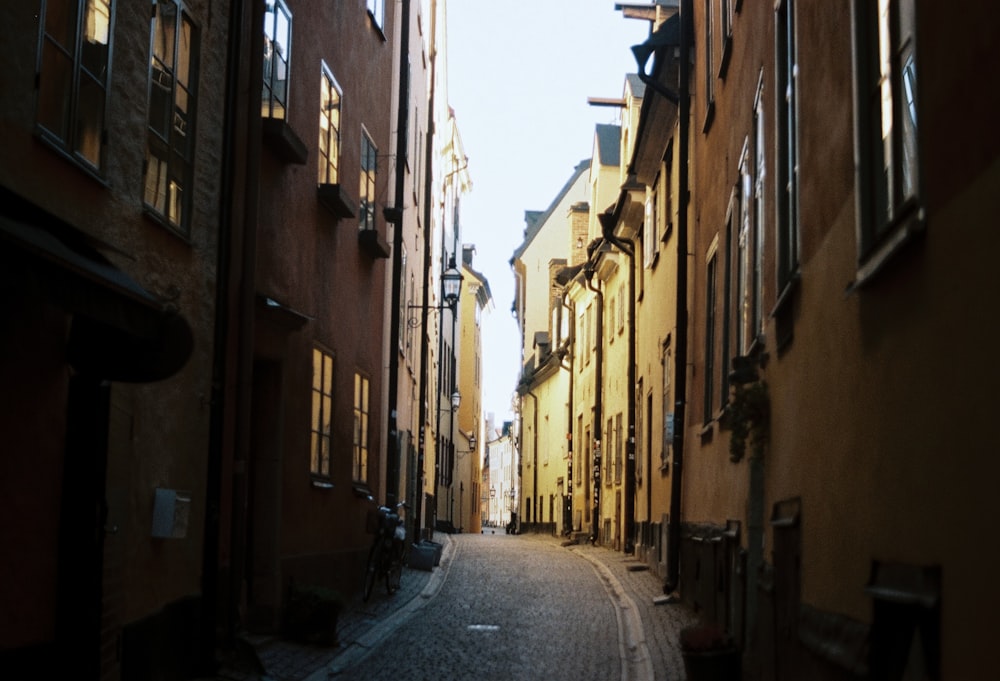 a narrow city street lined with tall buildings